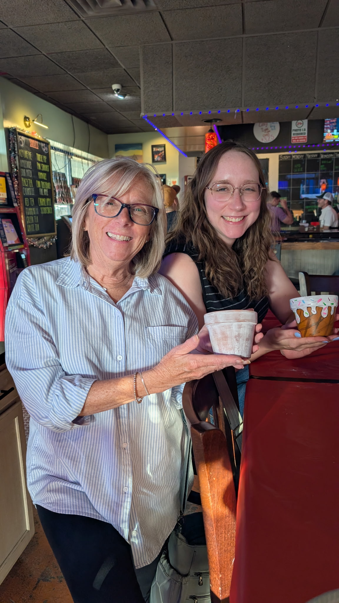 Guests showing painted craft pots inside North City Tavern